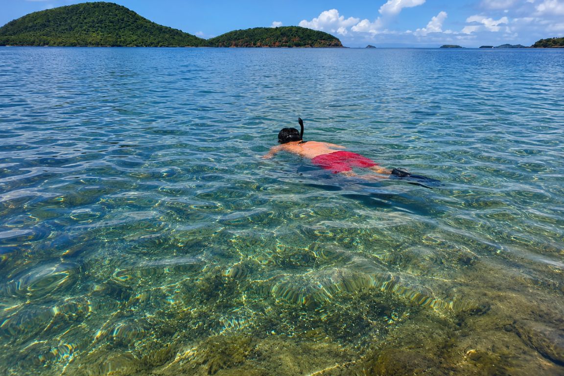 Beautiful view of Culebrita featuring pristine Caribbean water and a snorkeler discovering marine life during a tour with Culebra Tours