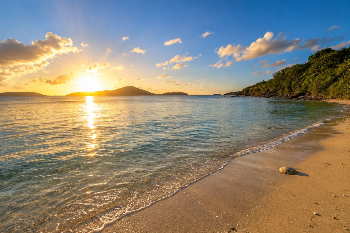 Golden sunset over Melones Beach with calm Caribbean waters and a peaceful shoreline during a guided island tour with Culebra Tours