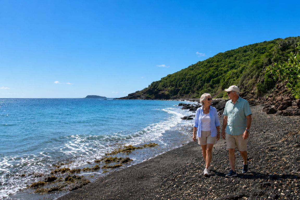 Visitors enjoying a relaxing walk on Punta Soldado Beach surrounded by turquoise waters and lush green hills during a tour with Culebra Tours